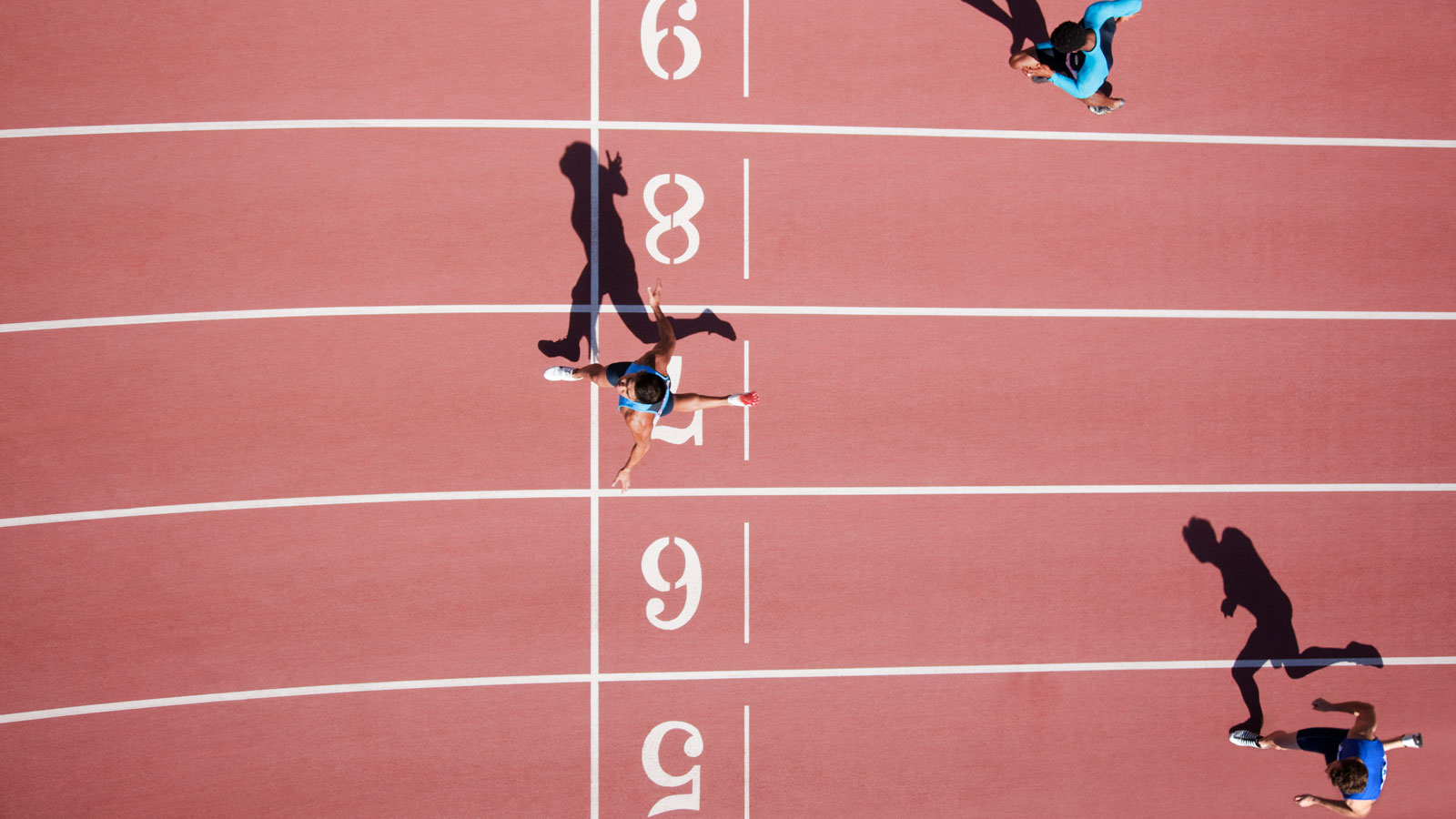 Runner crossing finishing line on track