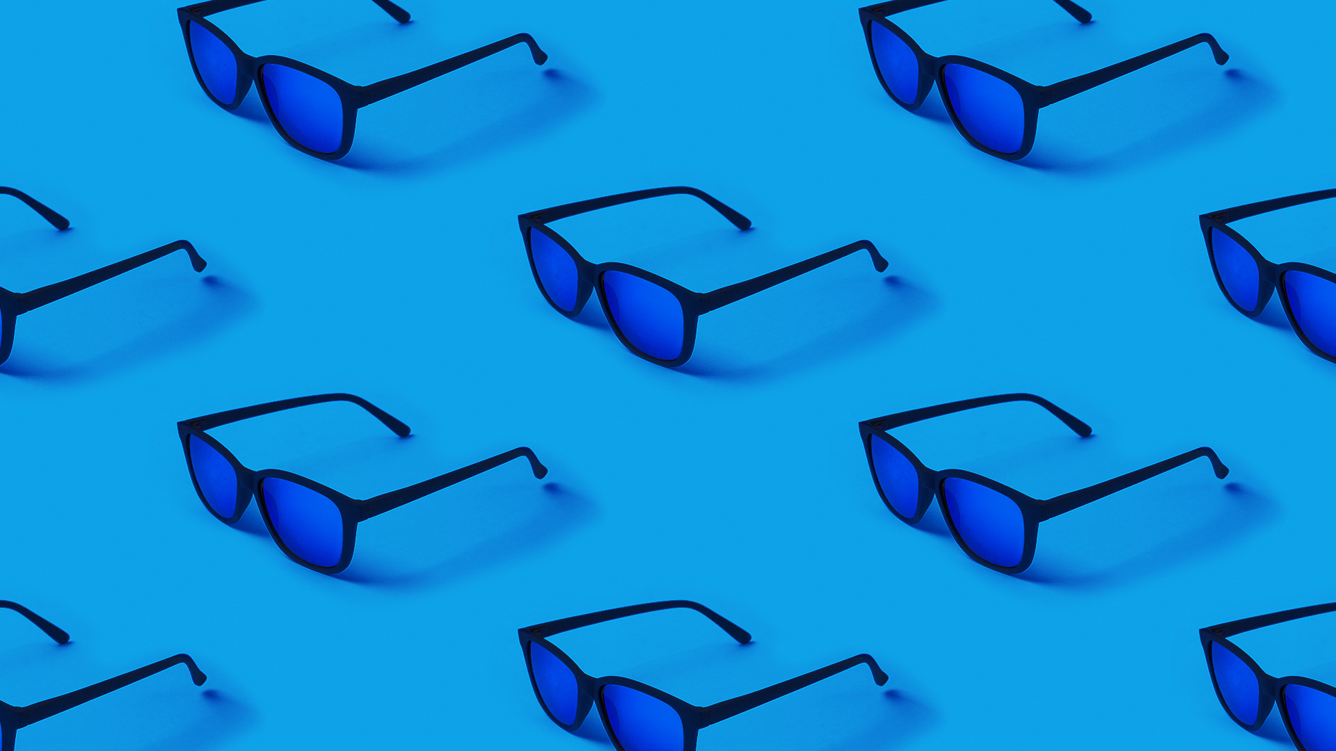Seamless pattern with trendy modern sunglasses on blue background. Men's fashion accessories. Cyan repeated pattern.