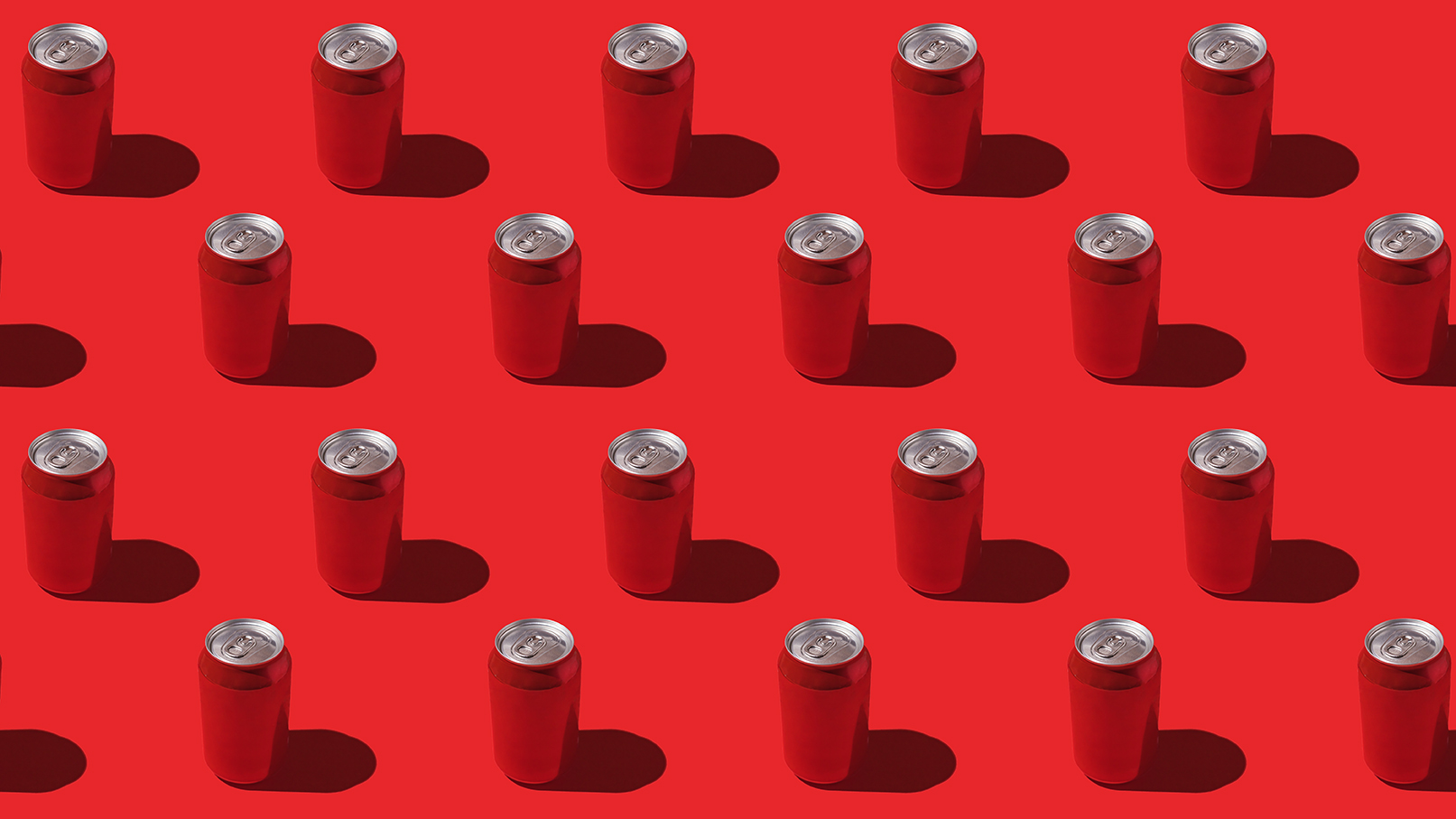 Red soda cans pattern with hard shadow on red background.