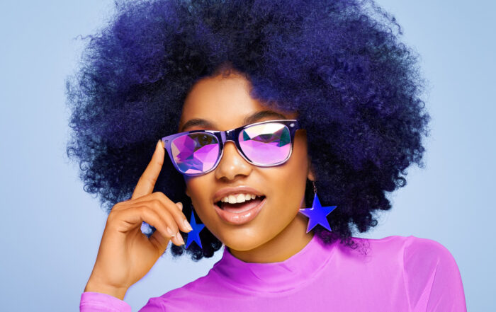 Beauty portrait of African American girl in colored sunglasses