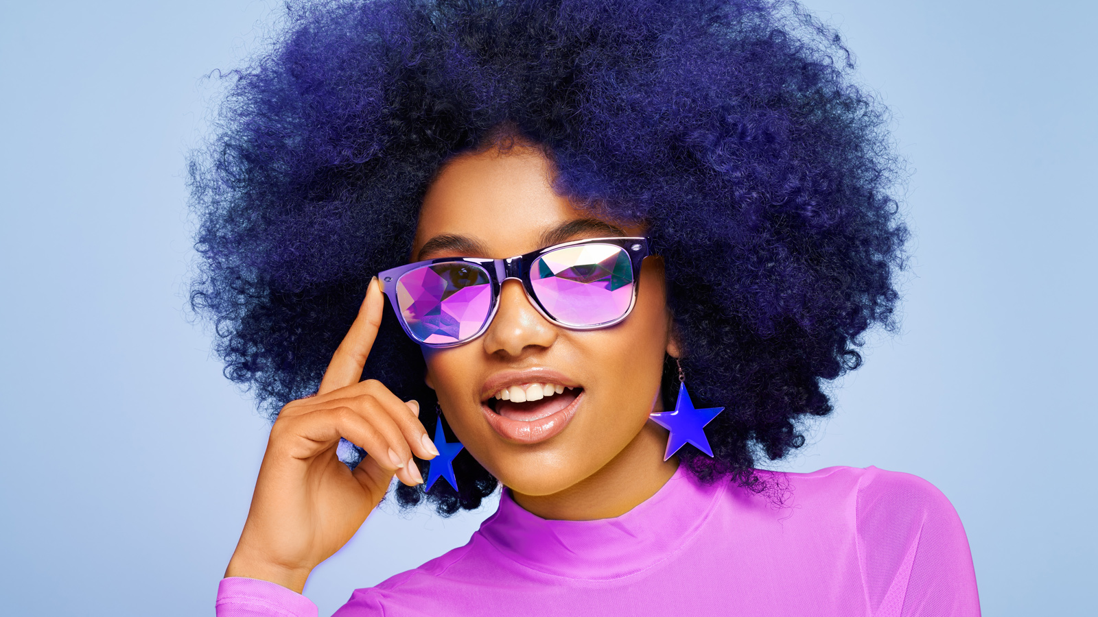 Beauty portrait of African American girl in colored sunglasses