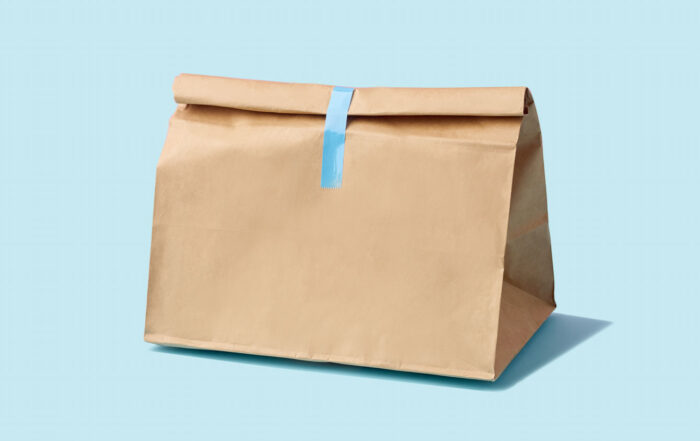 Brown paper bag for food delivery on blue background