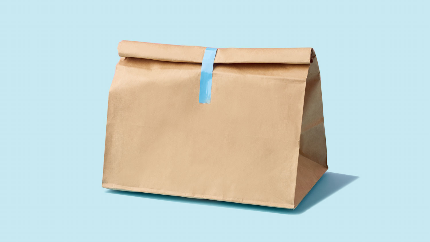 Brown paper bag for food delivery on blue background