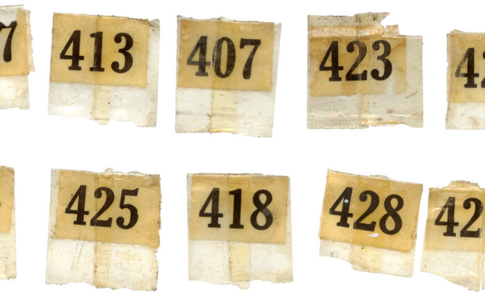 A collected of vintage number labels that came off an antique printers tray