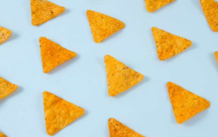 Nachos chips laid out on a soft blue background