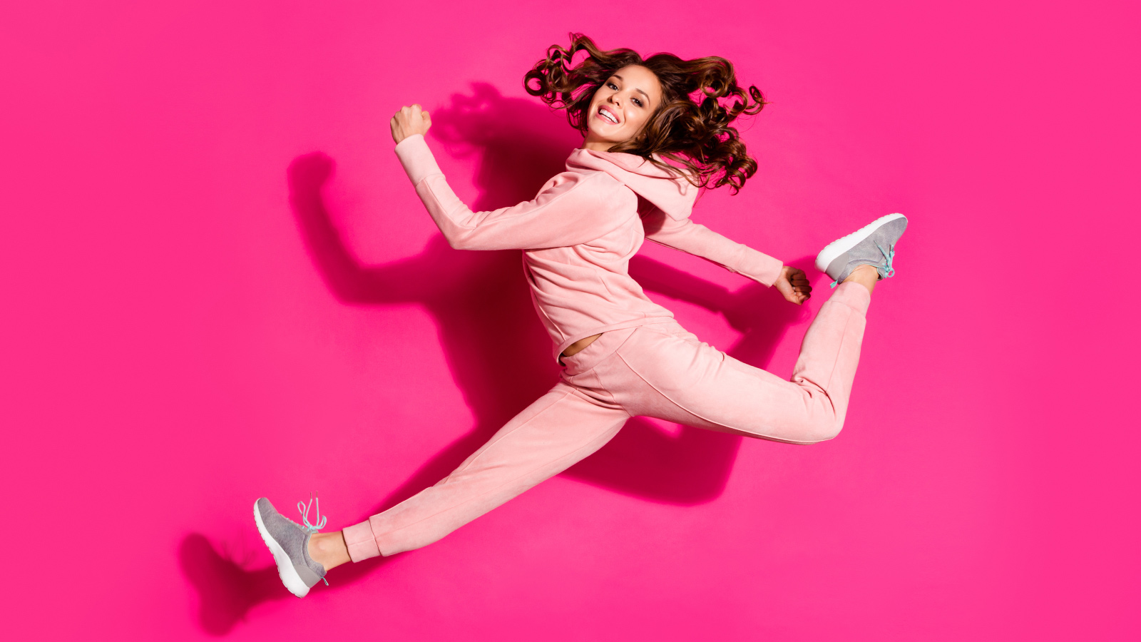 Full length body size photo jumping flight high smiling amazing she her lady hands arms help rushing shopping wearing modern casual pink costume suit pullover outfit isolated vibrant rose background