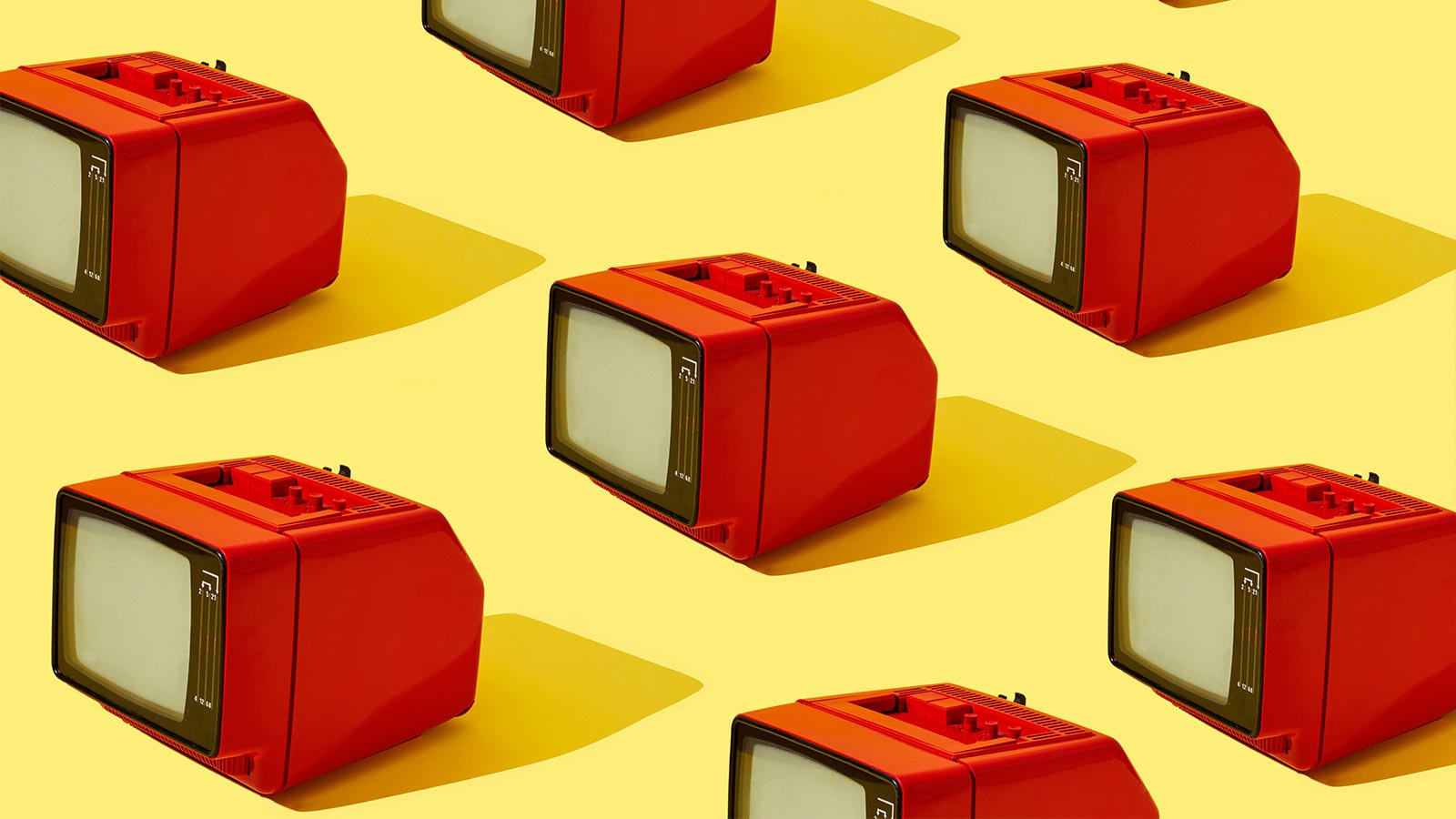 some red old analog television sets arranged in different lineas on a yellow background