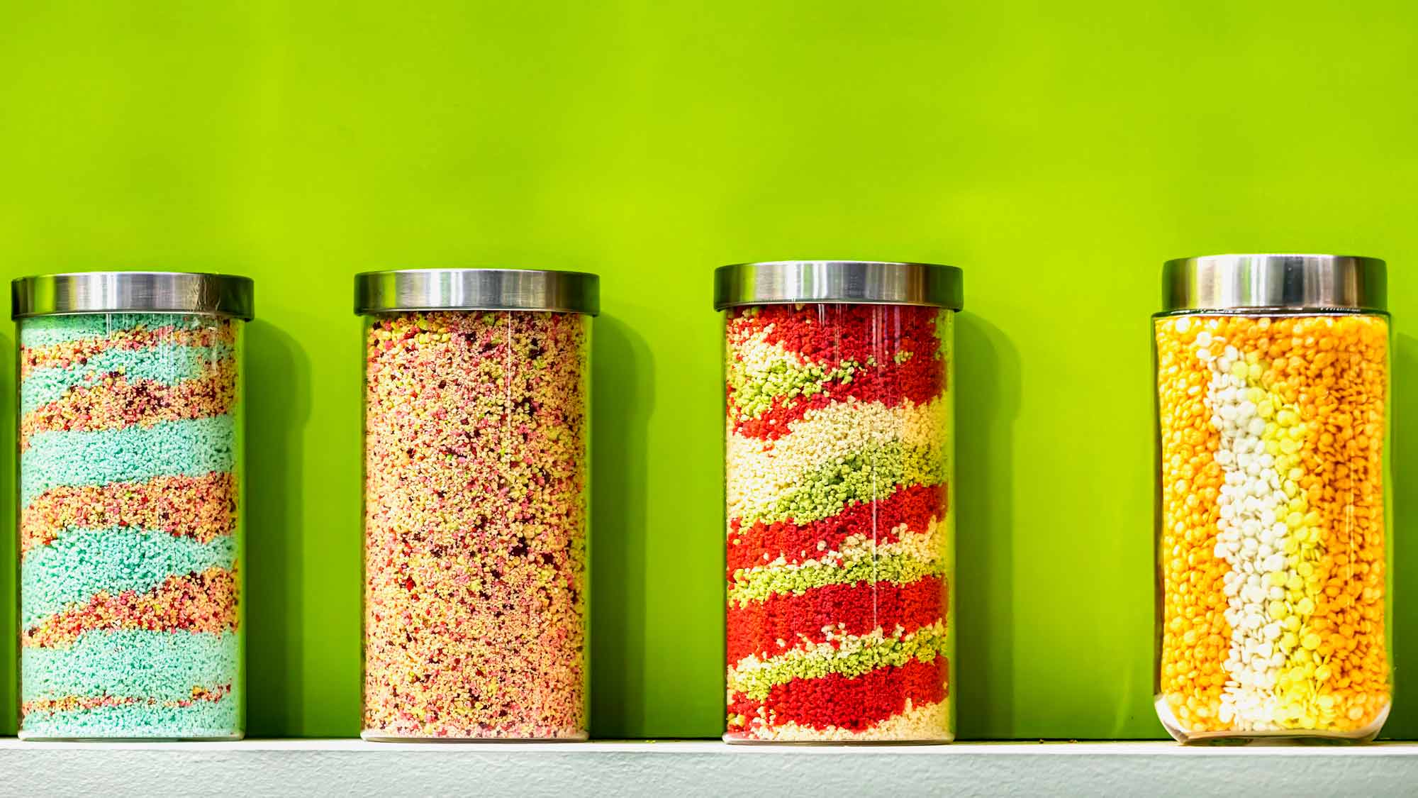 Group of Sweet and Salty Snacks in Glass Jars on The Shelf