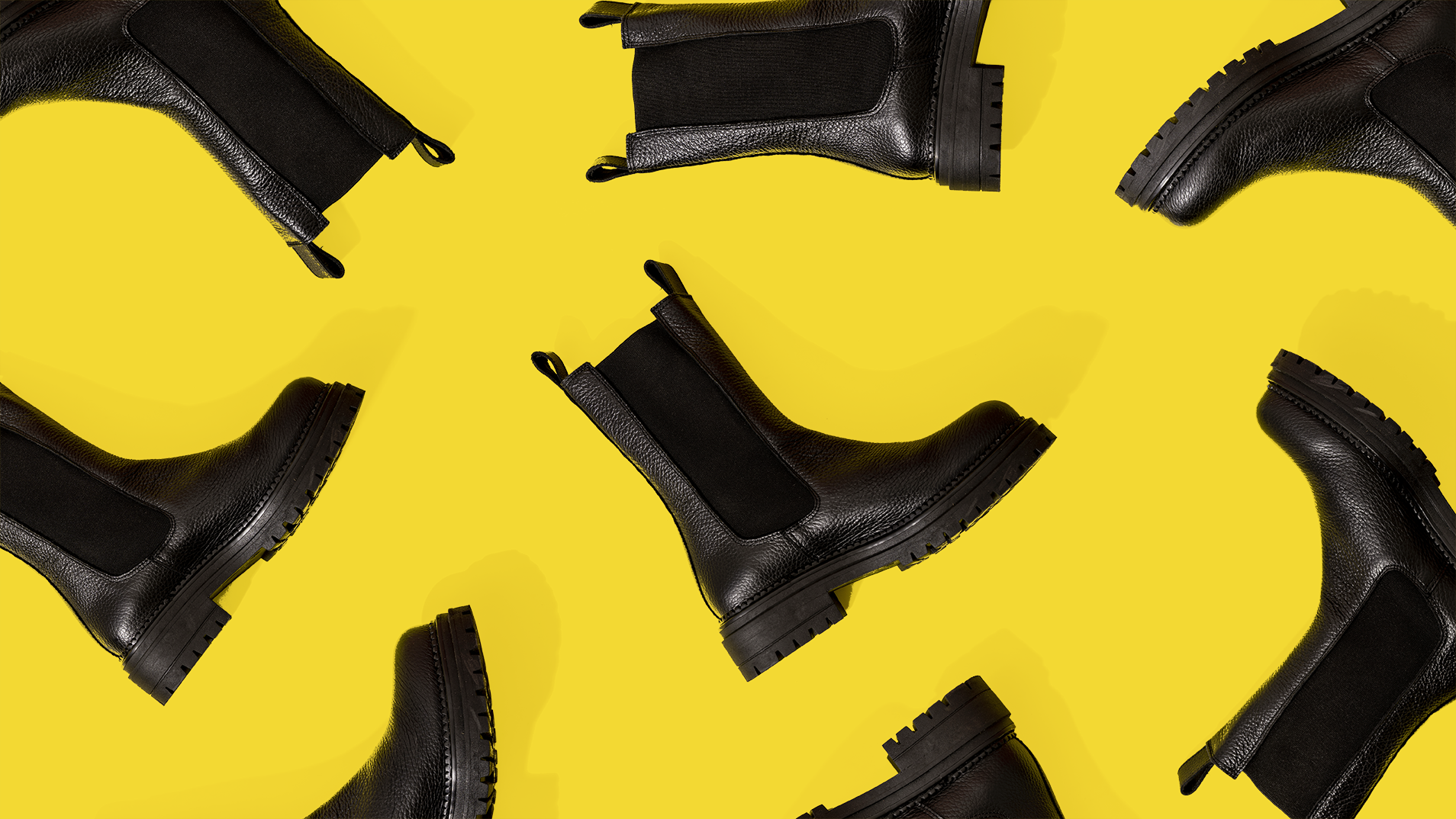 Pattern of black leather boots against yellow background