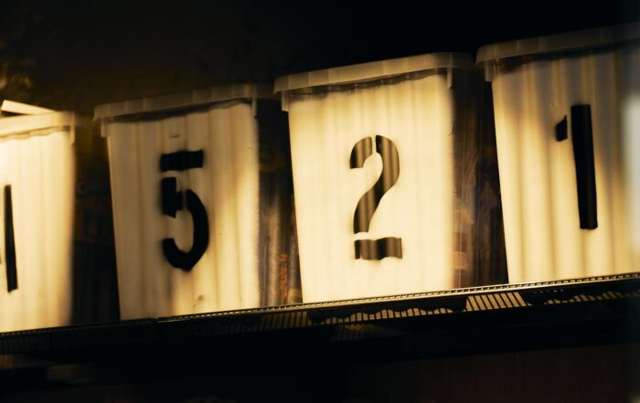 Group of containers with numbers in a row on a shelf in a warehouse in side view