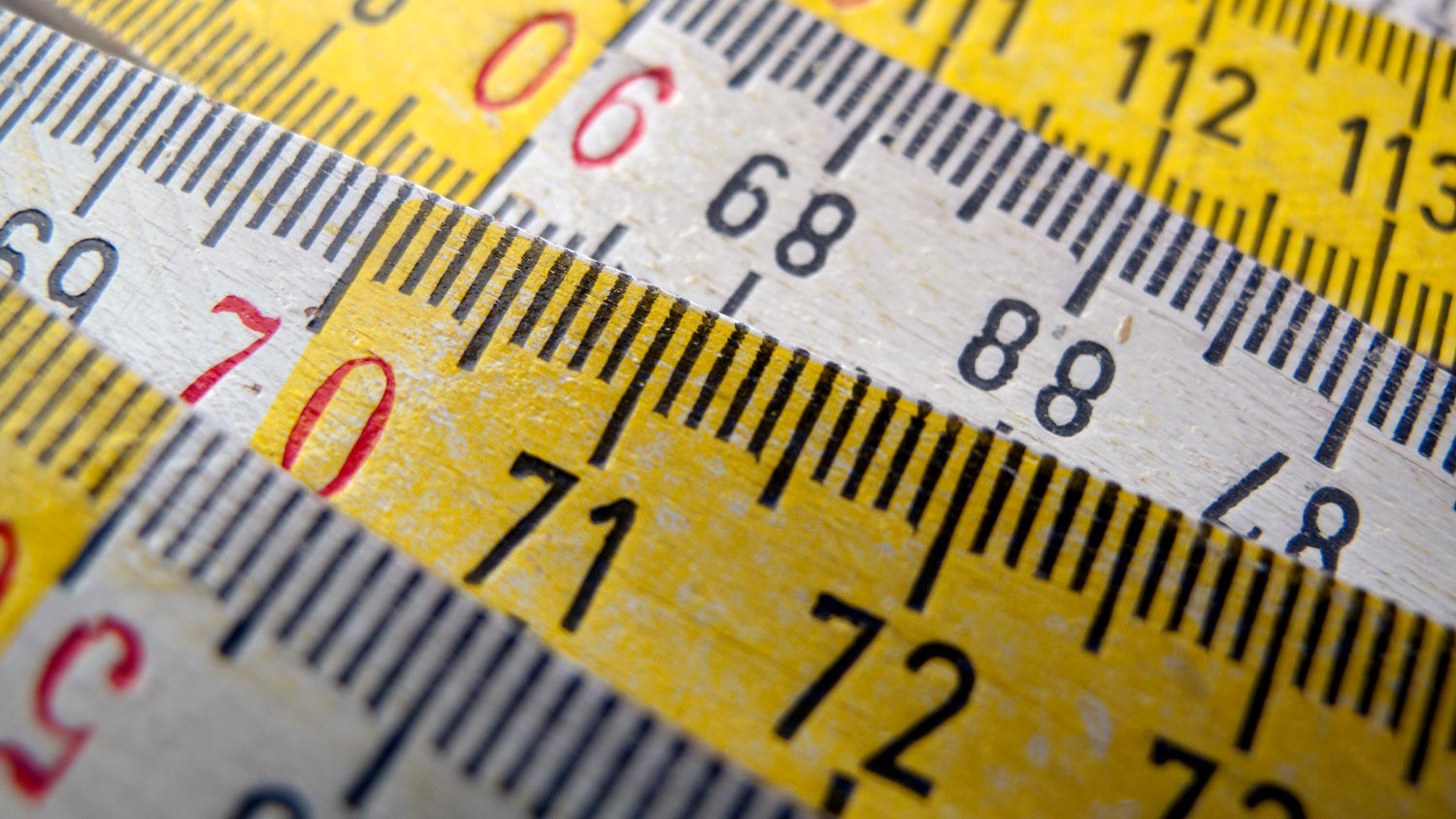 Close-up of wooden white and yellow ruler