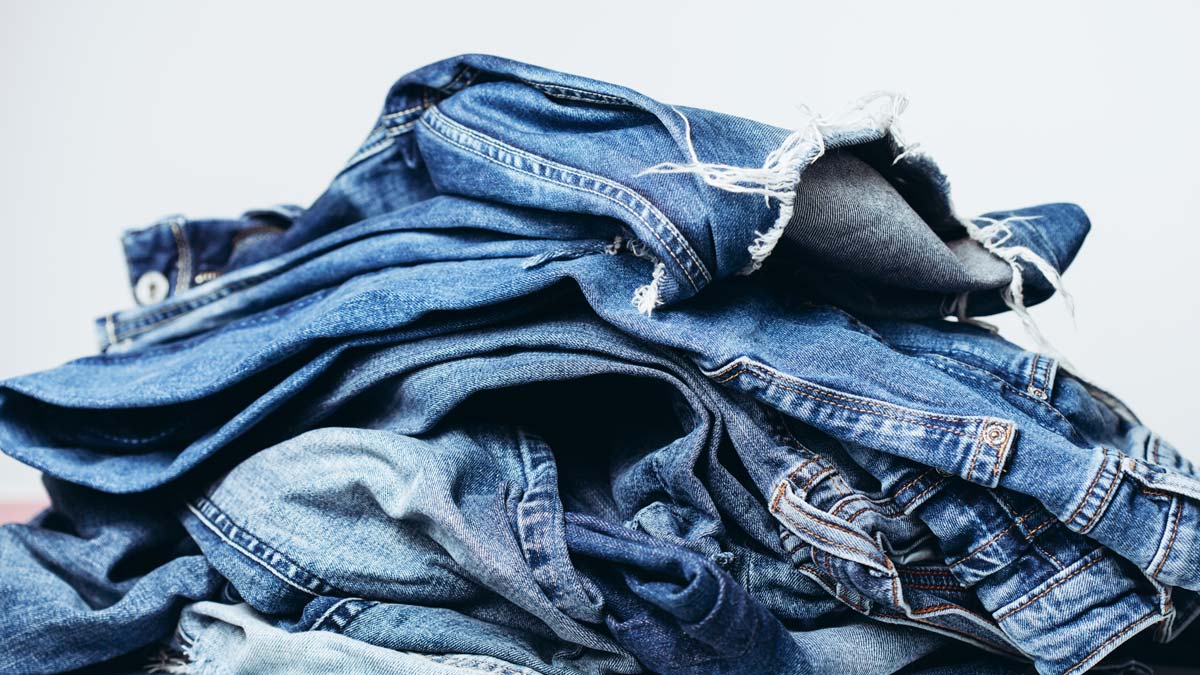 Stack of jeans on table. Zero waste concept