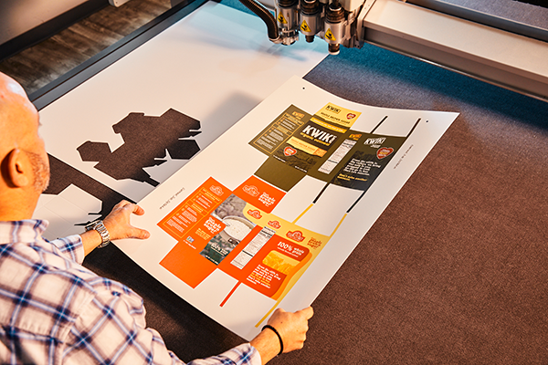 Quad employee reviewing product packaging prototypes Quad employee reviewing product packaging prototypes