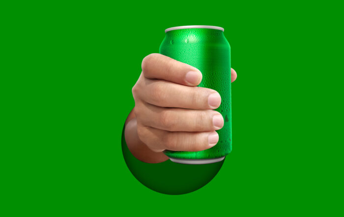 Hand holding green pop can