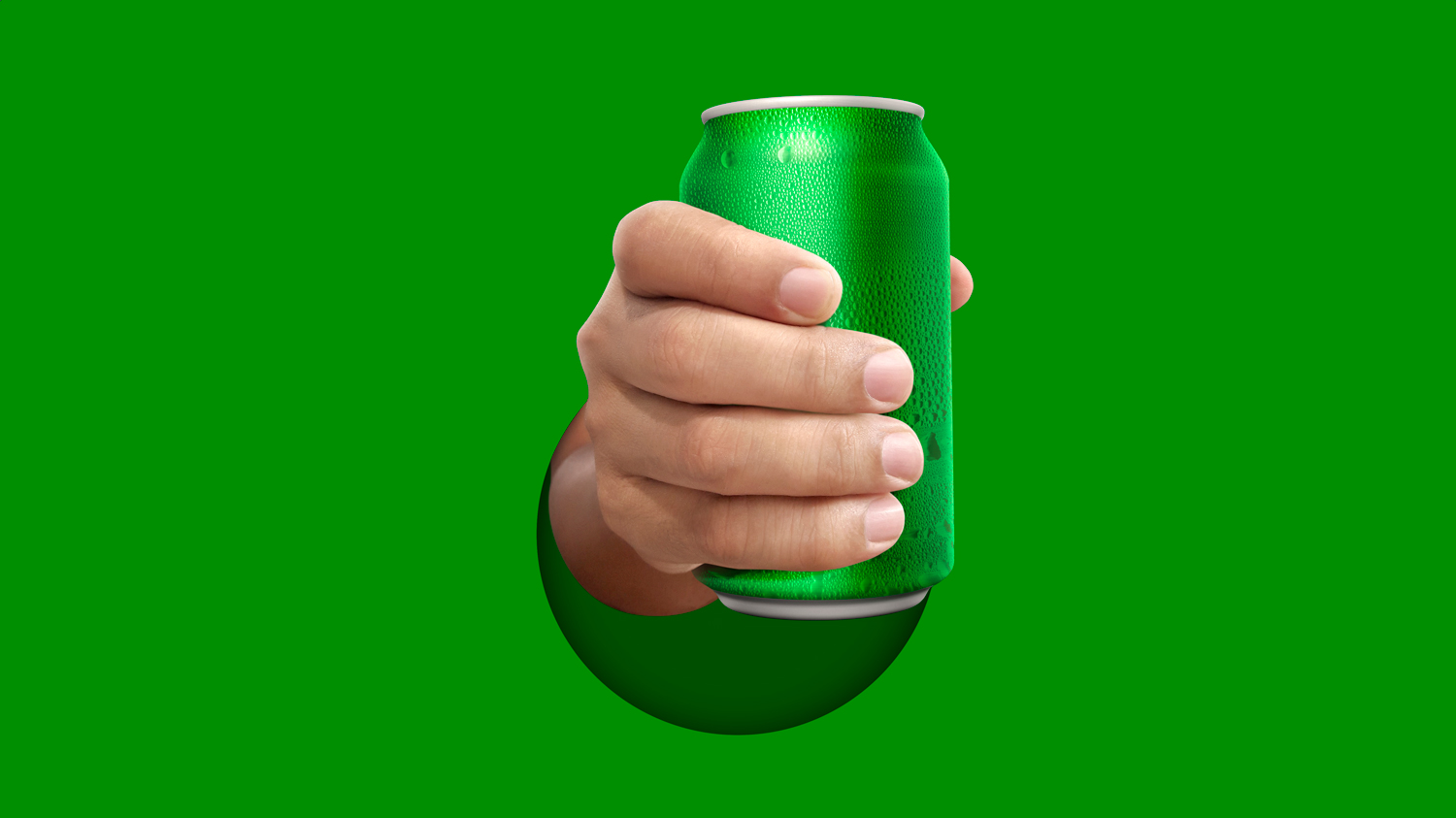 Hand holding green pop can
