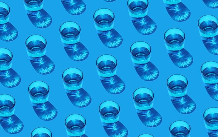 Repeating pattern of water glasses half filled