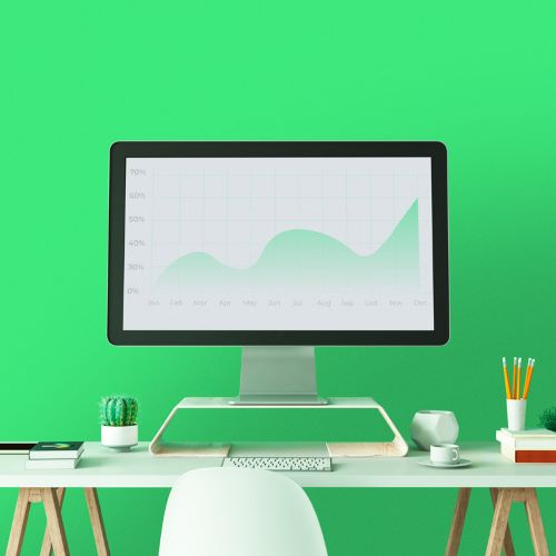 A desk with a large monitor showing test results via a line graph