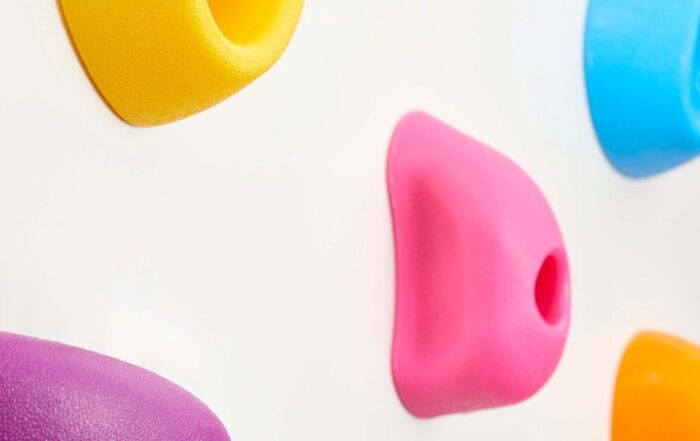 A closeup of a colorful rock climbing wall