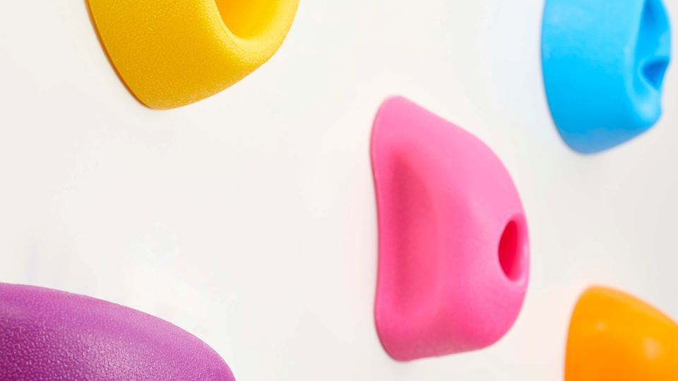 A closeup of a colorful rock climbing wall