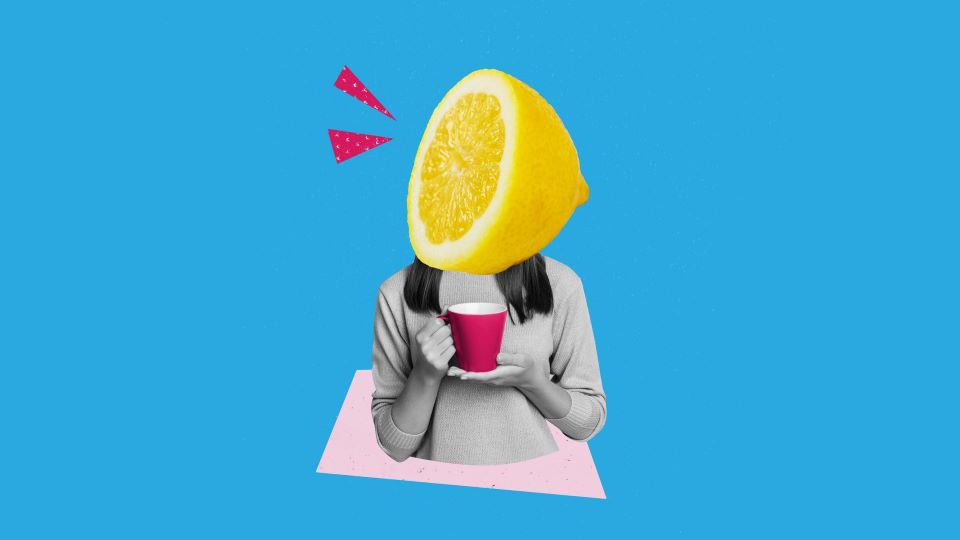 A lemonhead holding a red mug