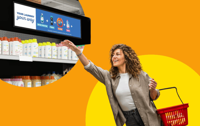 Person reaching for CPG products displayed on an end-cap with a retail media network screen