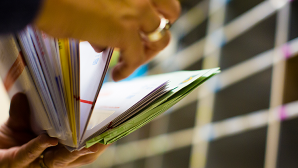 Person looking through their mail
