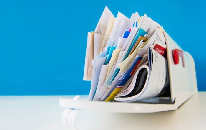 USPS mailbox overflowing with mail pieces