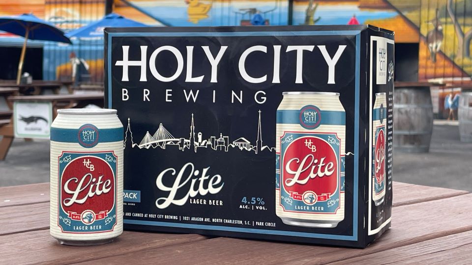 Holy City Brewing Lite Lager six-pack packaging on a patio table