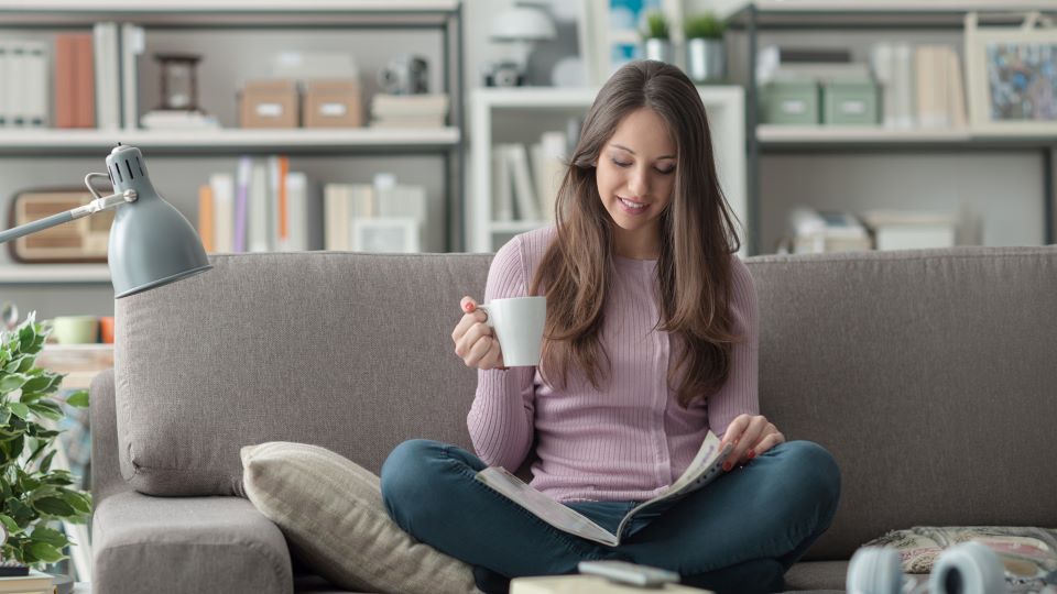 Consumer at home reading a holiday shopping catalog