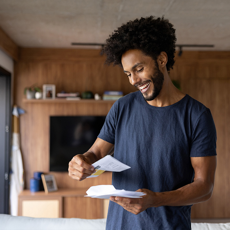 A consumer at home looking through their direct mail A consumer at home looking through their direct mail