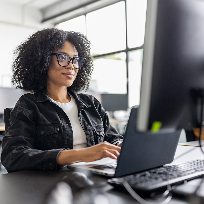 A marketing media specialist working on client work in the office