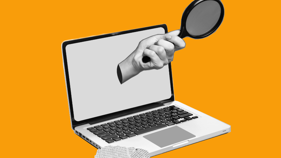 A hand holding a magnifying glass emerging from a laptop screen with a newspaper cutout in the bottom left corner of the image. The background is orange.