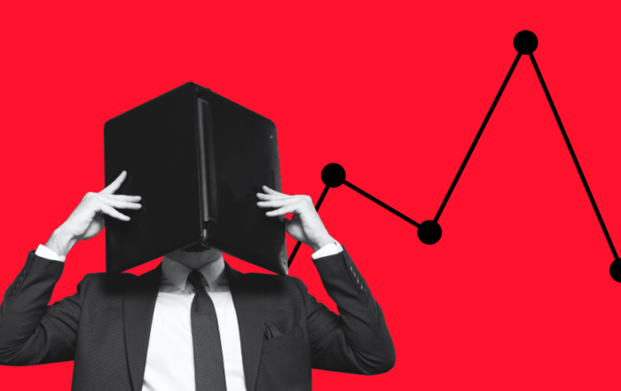 Someone covering their face with a notebook computer in front of a red background. Data points are behind them.