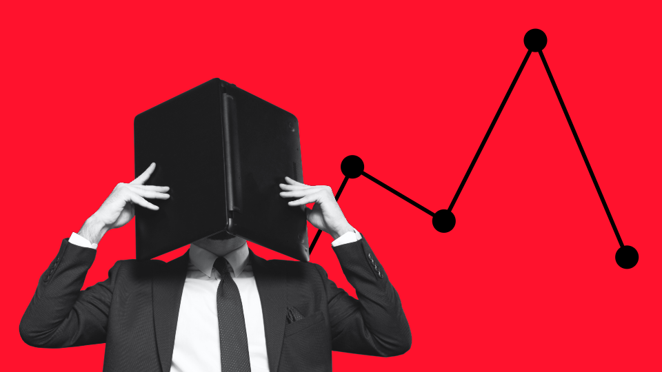 Someone covering their face with a notebook computer in front of a red background. Data points are behind them.