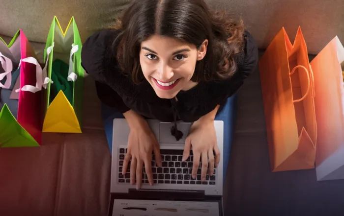 Consumer shopping online while surrounded by their purchases