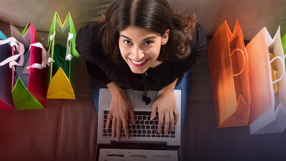 Consumer shopping online while surrounded by their purchases