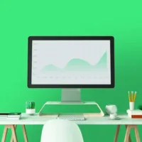 A desk with a large monitor showing test results via a line graph