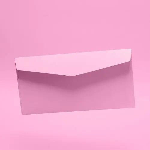 A pink postal envelope on a pink background