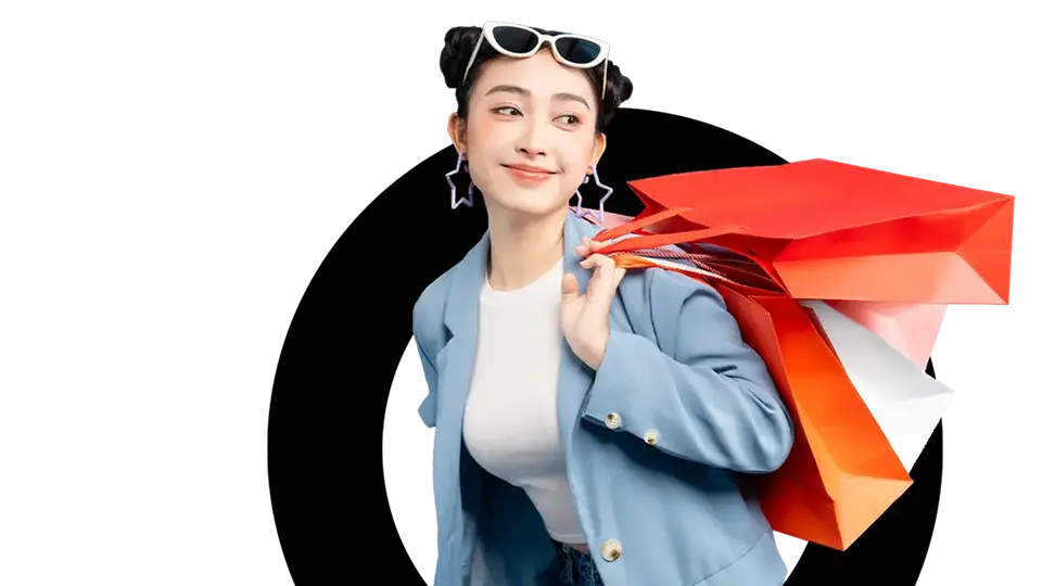 Happy consumer holds multiple shopping bags over their shoulder Happy consumer holds multiple shopping bags over their shoulder