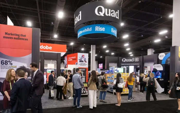 Quad's in-store display booth from Shoptalk 2026 inside a convention center.