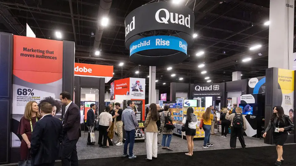Quad's in-store display booth from Shoptalk 2026 inside a convention center.