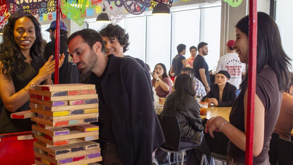 Rise employees playing with a jumble tower Rise employees playing with a jumble tower