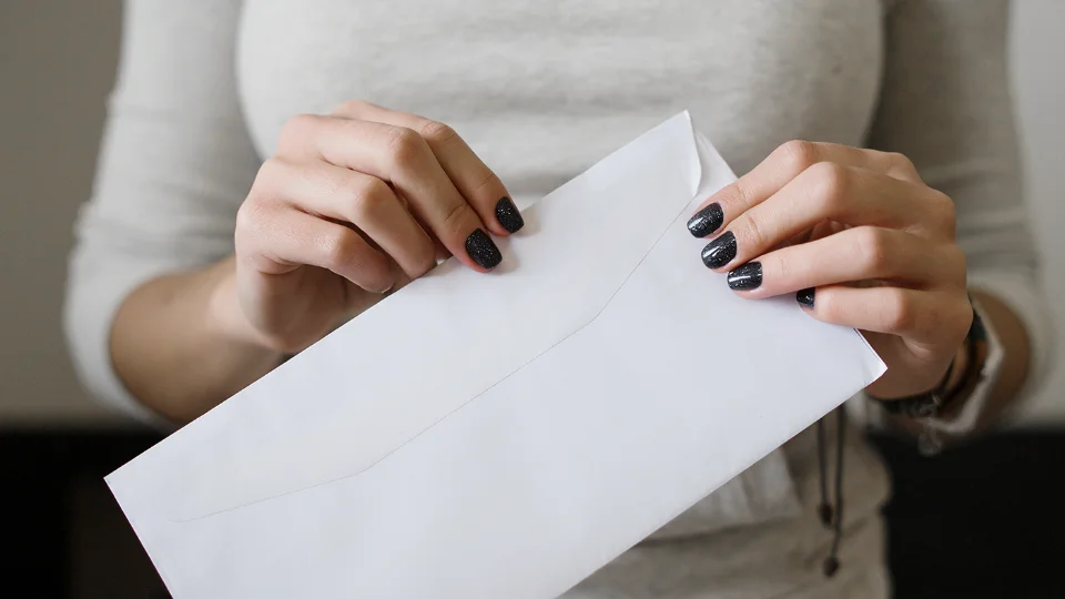 Consumer holding an envelope