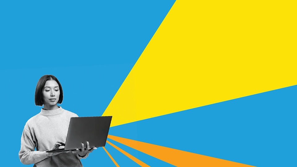A woman holding their laptop in front of a blue, orange and yellow background