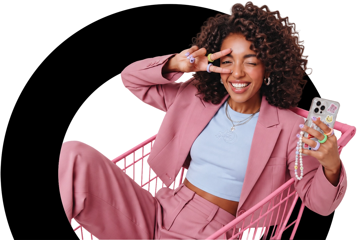 A happy shopper hanging out in a pink grocery cart